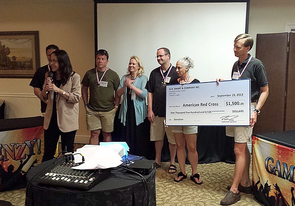 A group of people holding a check.