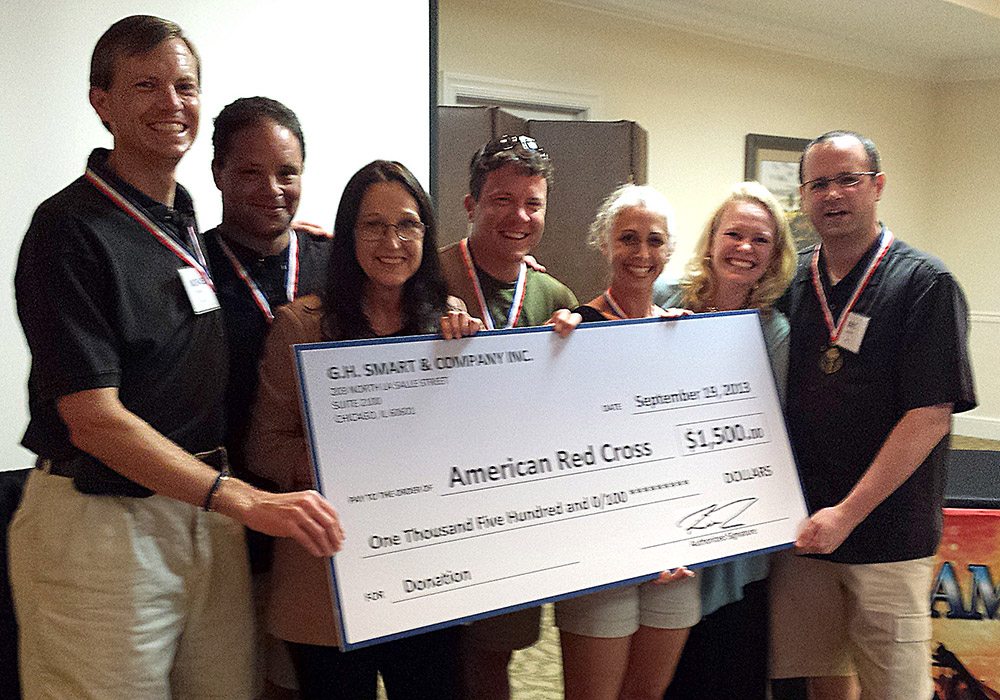 A group of people posing with a check.