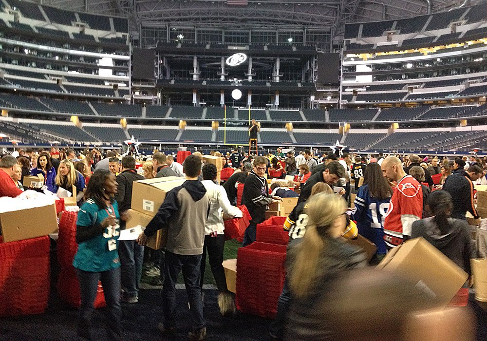 A group of people standing in a stadium.