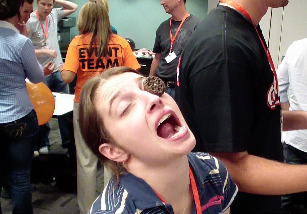 A woman with a donut in her mouth.