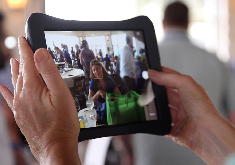 A person taking a picture with an ipad.