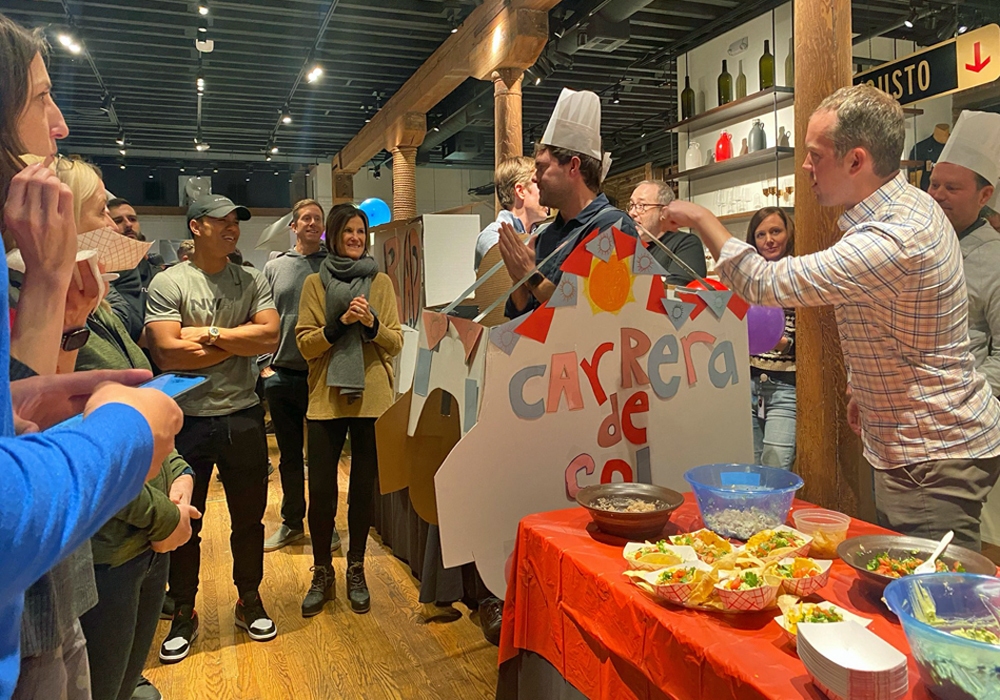 A group of people standing around a table.