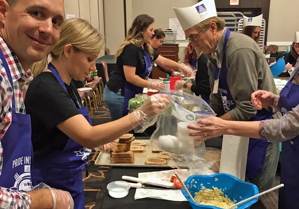 A group of people preparing food at a table.