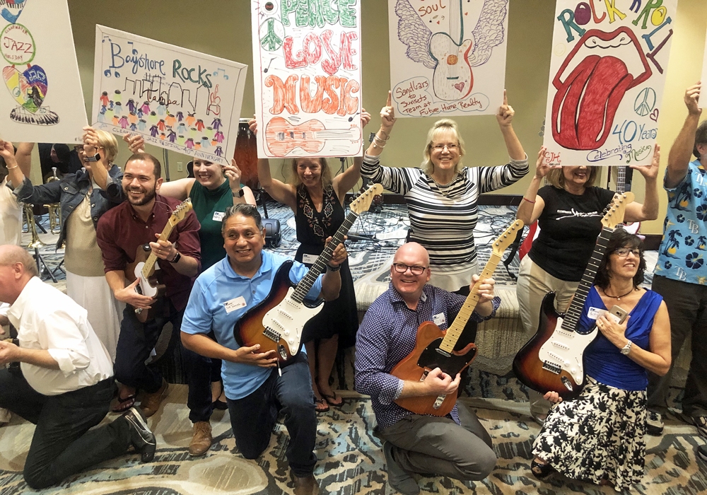 A group of people holding signs and guitars.
