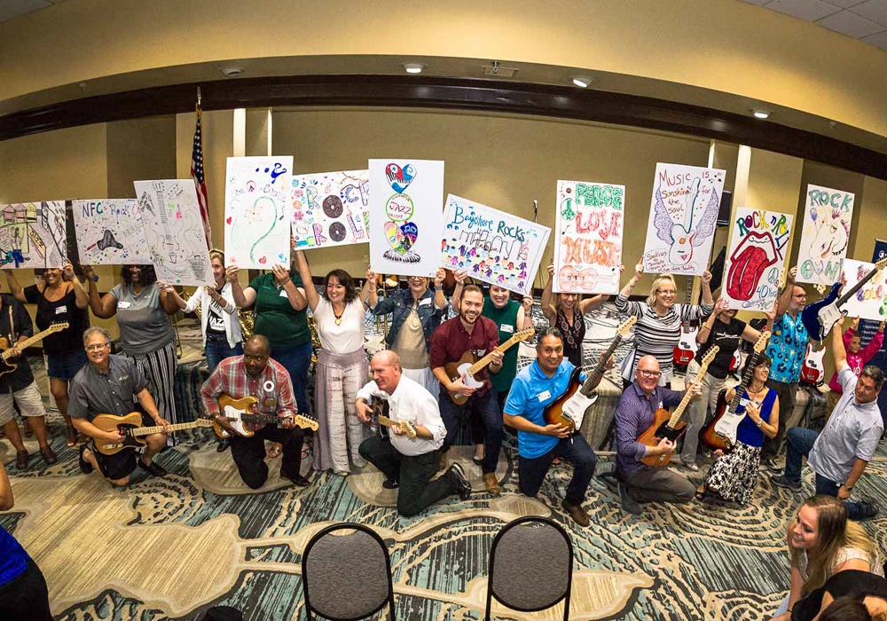 A group of people holding signs in a room.