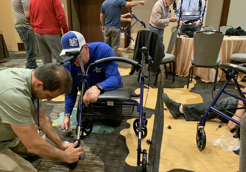 Two men working on a walker.
