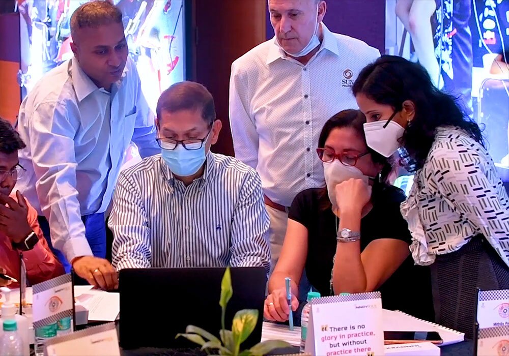 A group of people wearing face masks at a table.