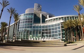 A large building with palm trees in front of it.