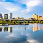 A city skyline reflected in a body of water.