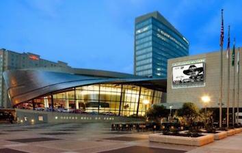 A modern building with a clock tower in the background.