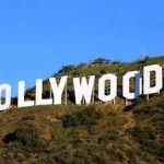 The hollywood sign is on top of a hill.