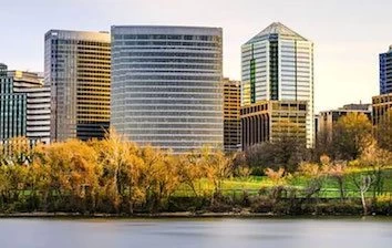 A city skyline with trees and a river.