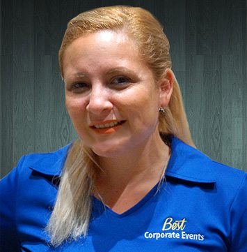 A woman in a blue shirt is posing for a photo.