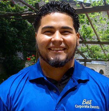 A man in a blue shirt smiles for the camera.