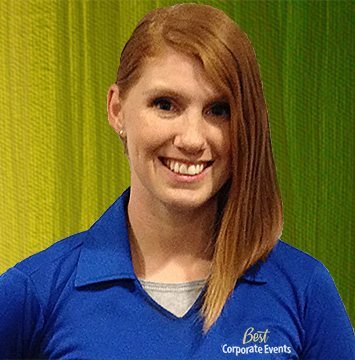 A woman in a blue shirt is posing for a photo.