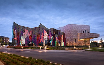 A building with a colorful facade at dusk.