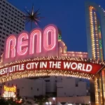 A neon sign that says reno the biggest city in the world.
