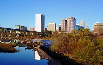 A city skyline reflected in a river.