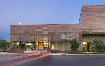 A building with a wooden exterior at dusk.