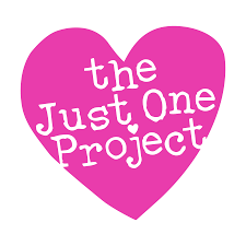 A pink heart with the words "the Just One Project" written in white, with some letters slightly tilted.