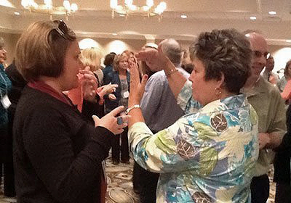 A group of people standing in a room.