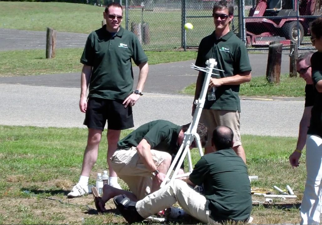 A group of men in green shirts.