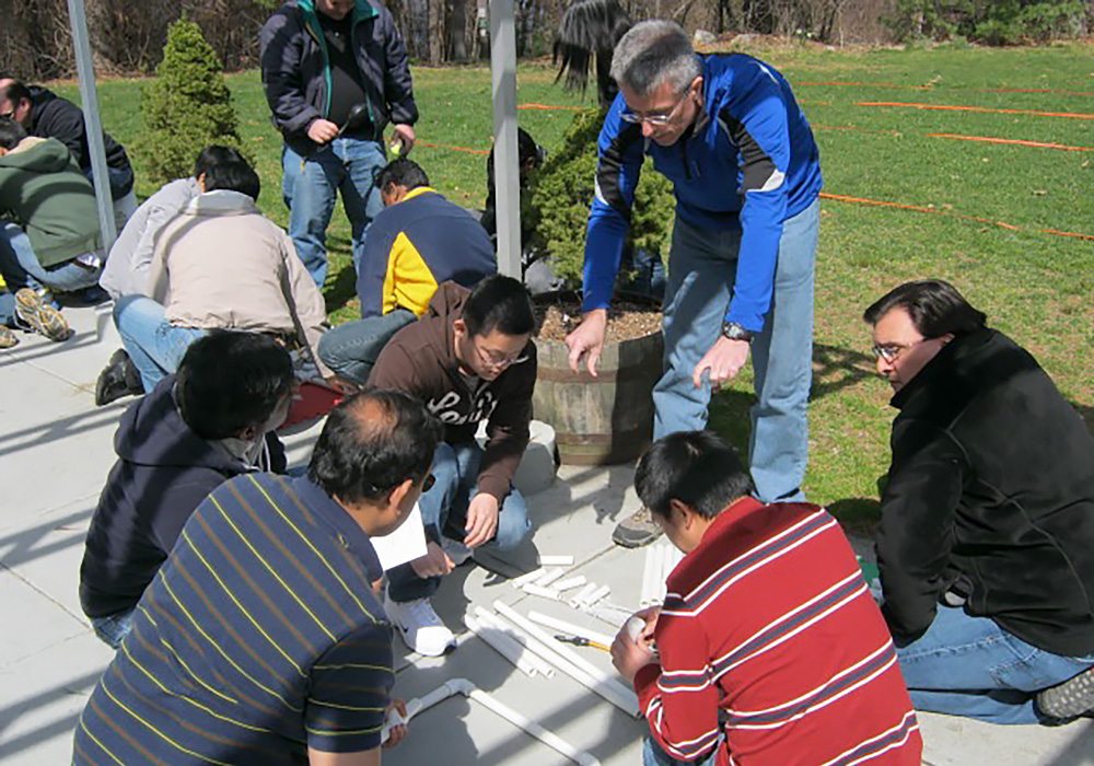 A group of people sitting on the ground.
