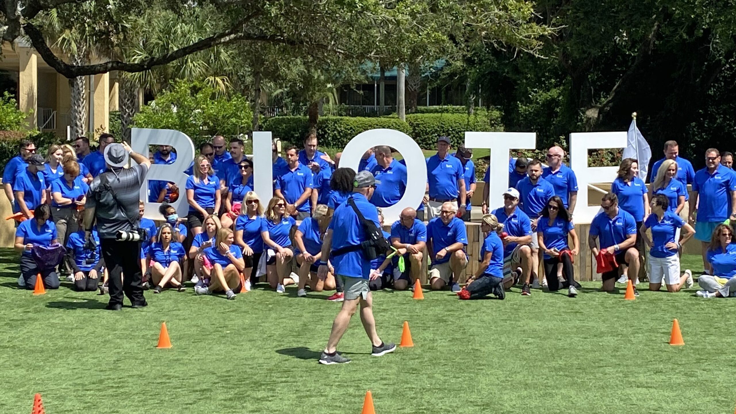 A group of people posing in front of a sign.