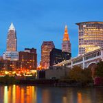 A city skyline reflected in a body of water.
