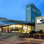 A modern building with a clock tower in the background.
