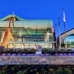 A building with a large glass facade at dusk.