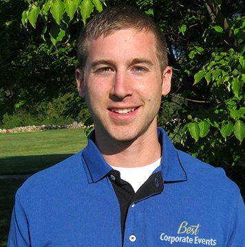 A young man wearing a blue shirt and black pants.
