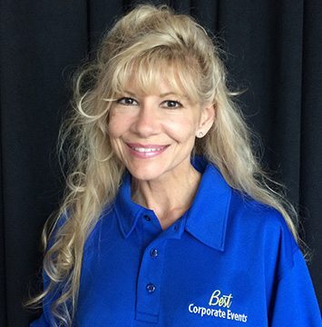 A woman in a blue polo posing for a photo.
