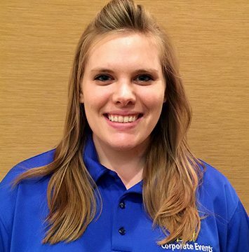 A smiling woman in a blue shirt.