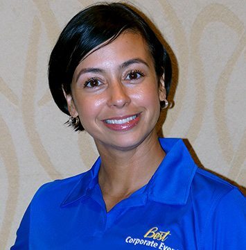 A woman in a blue polo posing for a photo.