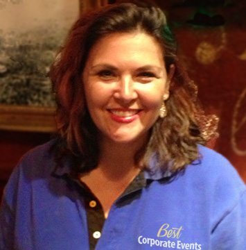A woman in a blue shirt smiling for the camera.