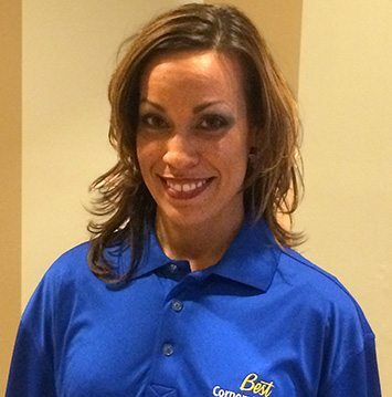 A woman in a blue polo posing for a photo.