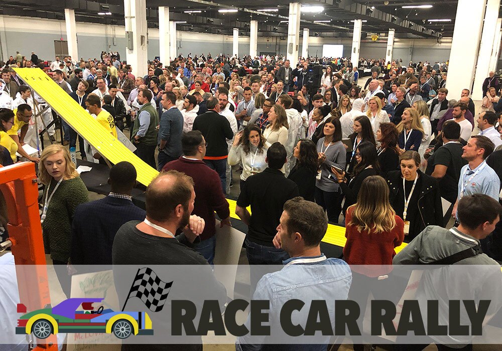 A crowd of people at a race car rally.