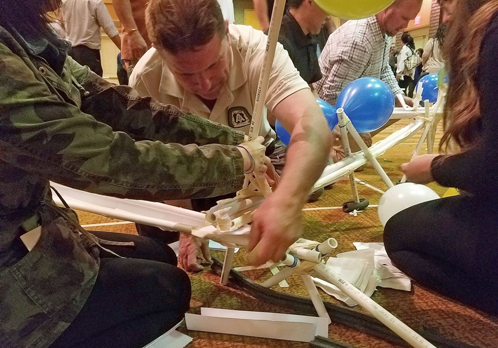 A group of people working on a balloon structure.
