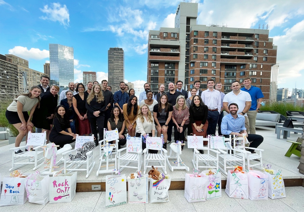 A group of people posing for a photo on a rooftop.