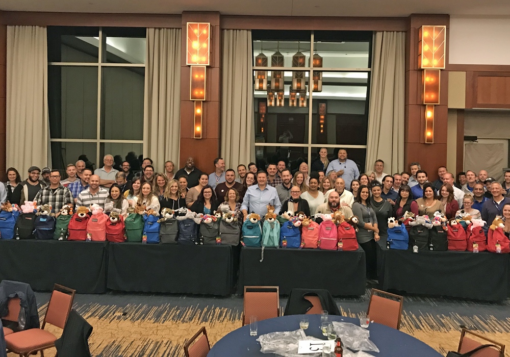 A group of people posing for a picture at a banquet.