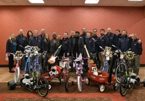 A group of people posing for a photo with bicycles.