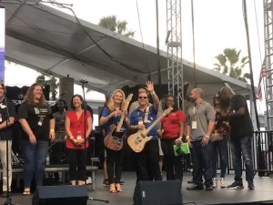 A group of people standing on stage at an event.