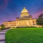 The state capitol building is lit up at dusk.
