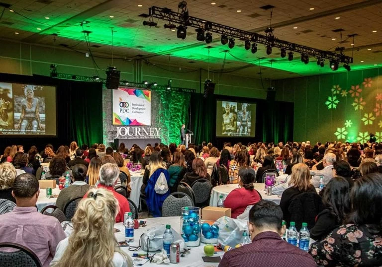 A large room full of people at a conference.