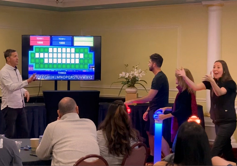A group of people playing a game in front of a tv.