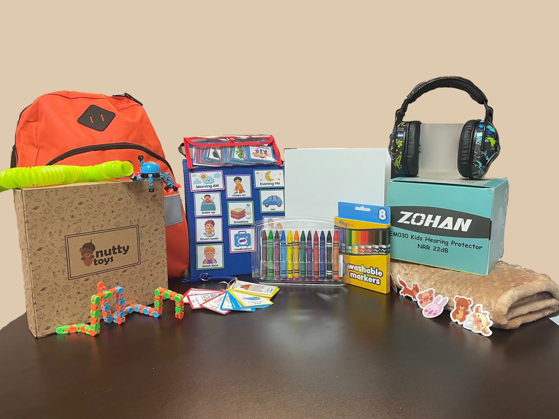 A table with a backpack, headphones, and other items.