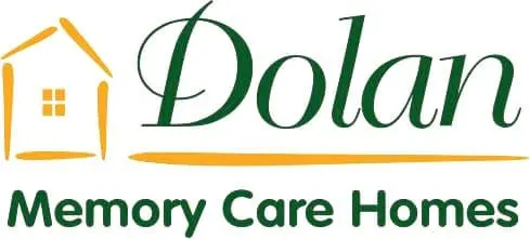 Logo of Dolan Memory Care Homes featuring a stylized house icon and the company's name in green, with "Memory Care Homes" written below in green text.