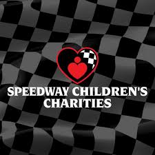 Logo of Speedway Children's Charities featuring a red heart with a checkered flag design on a black and white checkered background.