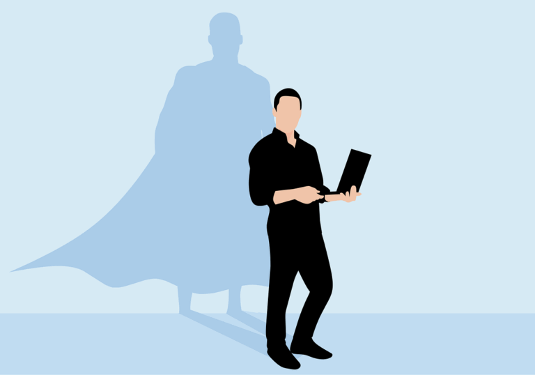 A person stands holding a laptop, their shadow behind them in the shape of a superhero wearing a cape—rising above the challenges of a bad boss.